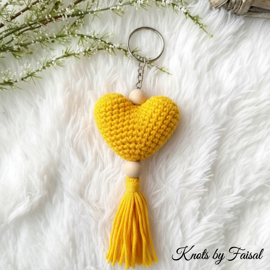 Yellow crochet heart keychain with tassel by Knots by Faisal